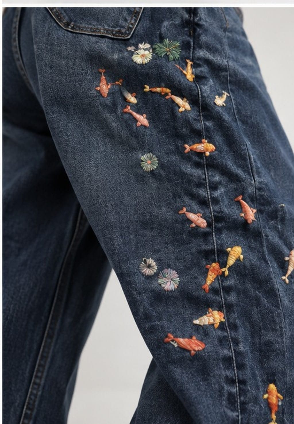 Close view of the raised koi in coral, orange and gold, with small flower bursts